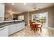 Cozy breakfast area with views to the patio, an overhead fan and stone tile flooring at 4015 Embassy Way, Lilburn, GA 30047