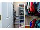 Walk-in closet with ample shelving and hanging space for storage at 4015 Embassy Way, Lilburn, GA 30047