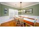 Traditional dining room with wainscoting, a wooden table, and a chandelier at 4015 Embassy Way, Lilburn, GA 30047