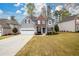 Beautiful two-story home with an attached two-car garage and landscaped front yard at 4015 Embassy Way, Lilburn, GA 30047