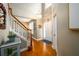 Grand foyer with hardwood floors, elegant chandelier, and staircase with wooden banister at 4015 Embassy Way, Lilburn, GA 30047