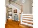 Open foyer with hardwood floors, staircase with white risers, and decorative display cabinet at 4015 Embassy Way, Lilburn, GA 30047