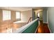 Upstairs hallway with hardwood floors and neutral paint throughout at 4015 Embassy Way, Lilburn, GA 30047