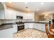 Modern kitchen with white cabinets, granite countertops, and stainless steel appliances at 4015 Embassy Way, Lilburn, GA 30047