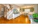 Open living area with hardwood floors, staircase with wood banister and adjacent dining area at 4015 Embassy Way, Lilburn, GA 30047