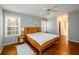 Comfortable main bedroom features a ceiling fan, hardwood floors and ensuite bathroom at 4015 Embassy Way, Lilburn, GA 30047
