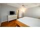 Relaxing main bedroom features a ceiling fan, hardwood floors and dresser with drawers at 4015 Embassy Way, Lilburn, GA 30047