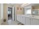 A bathroom with a dual sink vanity, a shower, and a doorway leading to another room at 2160 Liberty Hts, Fairburn, GA 30213