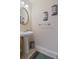 Half bathroom featuring a pedestal sink, large mirror, and decorative wall art at 2160 Liberty Hts, Fairburn, GA 30213