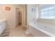 A bathroom with a walk-in shower, a garden tub, and a doorway leading to another room at 2160 Liberty Hts, Fairburn, GA 30213
