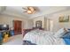 A bedroom featuring an interesting ceiling fan, a king bed, and an en suite bathroom at 2160 Liberty Hts, Fairburn, GA 30213