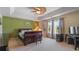 A bedroom with a decorative ceiling fan, a king bed, and large windows at 2160 Liberty Hts, Fairburn, GA 30213