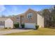 Beautiful home with siding on the side and a two-car garage with green shrubs at 2160 Liberty Hts, Fairburn, GA 30213