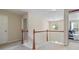 Hallway featuring an open stairway with a decorative wooden banister and neutral colored walls at 2160 Liberty Hts, Fairburn, GA 30213