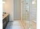 Modern bathroom featuring a glass-enclosed shower and double sink vanity at 3489 Central Park Dr, Loganville, GA 30052