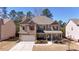 Charming brick-and-siding two-story home with a well-manicured front yard and covered entryway at 3489 Central Park Dr, Loganville, GA 30052
