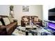 Comfortable living room with leather sofas, modern table, and entertainment setup at 3489 Central Park Dr, Loganville, GA 30052