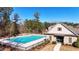Community pool and clubhouse surrounded by a fence and landscaping at 3489 Central Park Dr, Loganville, GA 30052