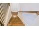 Wooden staircase with white risers and a dark wooden railing at 3489 Central Park Dr, Loganville, GA 30052