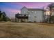 The backyard has an expansive lawn and a multi-level deck, providing ample space for outdoor activities and entertaining at 4980 Wildeoak Trl, Douglasville, GA 30135
