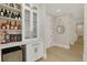 Custom bar area with wine storage, glass cabinets, and countertop space at 4980 Wildeoak Trl, Douglasville, GA 30135