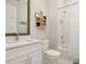 Well-lit bathroom with white cabinetry, subway tiled shower, and decorative shelving at 4980 Wildeoak Trl, Douglasville, GA 30135