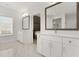 Bathroom featuring double sinks with white cabinetry, large mirrors, and modern fixtures at 4980 Wildeoak Trl, Douglasville, GA 30135
