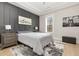 Modern bedroom features a gray accent wall, plush carpet, and natural light at 4980 Wildeoak Trl, Douglasville, GA 30135