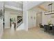 Bright open foyer leads to a formal dining area with luxury vinyl plank flooring and staircase to upper level at 4980 Wildeoak Trl, Douglasville, GA 30135
