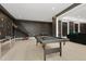 The game room has a pool table, basketball hoop, and a scooter, providing various recreational activities at 4980 Wildeoak Trl, Douglasville, GA 30135