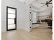 Office with open doors, built-in desk with drawers and bench, floating shelves, and natural light at 4980 Wildeoak Trl, Douglasville, GA 30135
