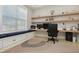 Home office boasts built-in shelving, a cushioned bench, natural light, and luxury vinyl plank flooring at 4980 Wildeoak Trl, Douglasville, GA 30135