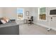 Bright home office with natural light, a modern desk, and a comfortable couch at 4980 Wildeoak Trl, Douglasville, GA 30135