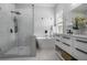 Modern bathroom features a glass shower, soaking tub, and dual vanity with stylish black fixtures at 652 Hugh Sw St, Atlanta, GA 30310