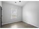 Neutral bedroom with wood-look floors and a bright window at 652 Hugh Sw St, Atlanta, GA 30310