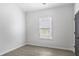 Bright, neutral bedroom featuring a large window for natural light and modern flooring at 652 Hugh Sw St, Atlanta, GA 30310