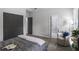 Well-lit bedroom with a view into the ensuite bathroom, a comfortable chair, and grey tones at 652 Hugh Sw St, Atlanta, GA 30310