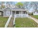 Charming gray home featuring a covered front porch and a welcoming entrance at 652 Hugh Sw St, Atlanta, GA 30310