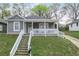 Charming gray home featuring a covered front porch and well-maintained landscaping at 652 Hugh Sw St, Atlanta, GA 30310
