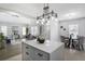 Open kitchen and living area with large island, stylish lighting, and dining area at 652 Hugh Sw St, Atlanta, GA 30310