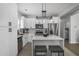 Contemporary kitchen with white cabinets, stainless appliances, and island with seating at 652 Hugh Sw St, Atlanta, GA 30310