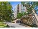 A mid-rise apartment building is shown with views of mature trees all around at 1 Biscayne Nw Dr # 410, Atlanta, GA 30309