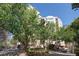 A mid-rise apartment building is surrounded by mature trees and landscaping at 1 Biscayne Nw Dr # 410, Atlanta, GA 30309