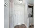 Hallway with washer/dryer unit, neutral paint, and wood-look floors at 1 Biscayne Nw Dr # 410, Atlanta, GA 30309