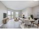 Bright living room with modern gray decor, wood floors, and balcony access at 1 Biscayne Nw Dr # 410, Atlanta, GA 30309