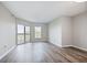 Empty living room with hardwood floors and balcony access at 1 Biscayne Nw Dr # 410, Atlanta, GA 30309
