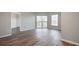 Vacant living room featuring hardwood floors and balcony views at 1 Biscayne Nw Dr # 410, Atlanta, GA 30309