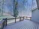 Spacious back deck overlooks a wooded backyard featuring natural views and wooden railings at 423 Eagle Ridge Trl, Canton, GA 30114