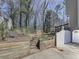 View of the home's backyard featuring a wooden fence and stair access to the upper yard area at 423 Eagle Ridge Trl, Canton, GA 30114
