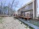 Backyard view featuring a deck, stone walkway, and mature trees for a secluded outdoor space at 423 Eagle Ridge Trl, Canton, GA 30114